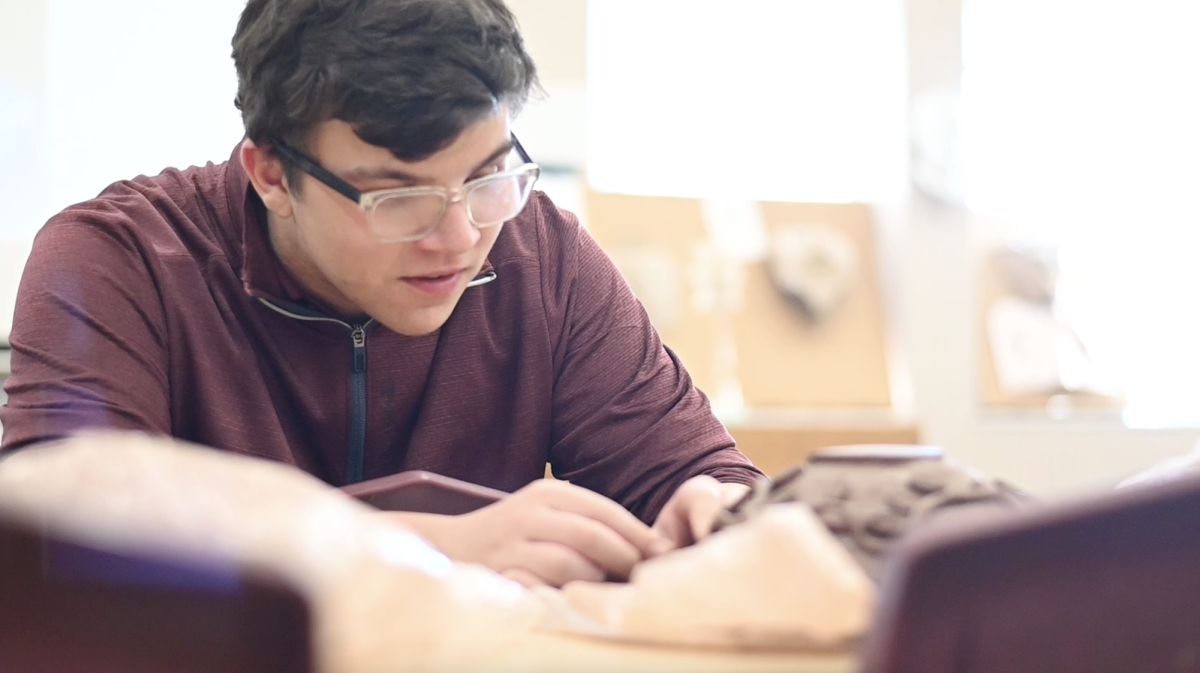 Ben Figge '27 works with clay during a sculpting class. 